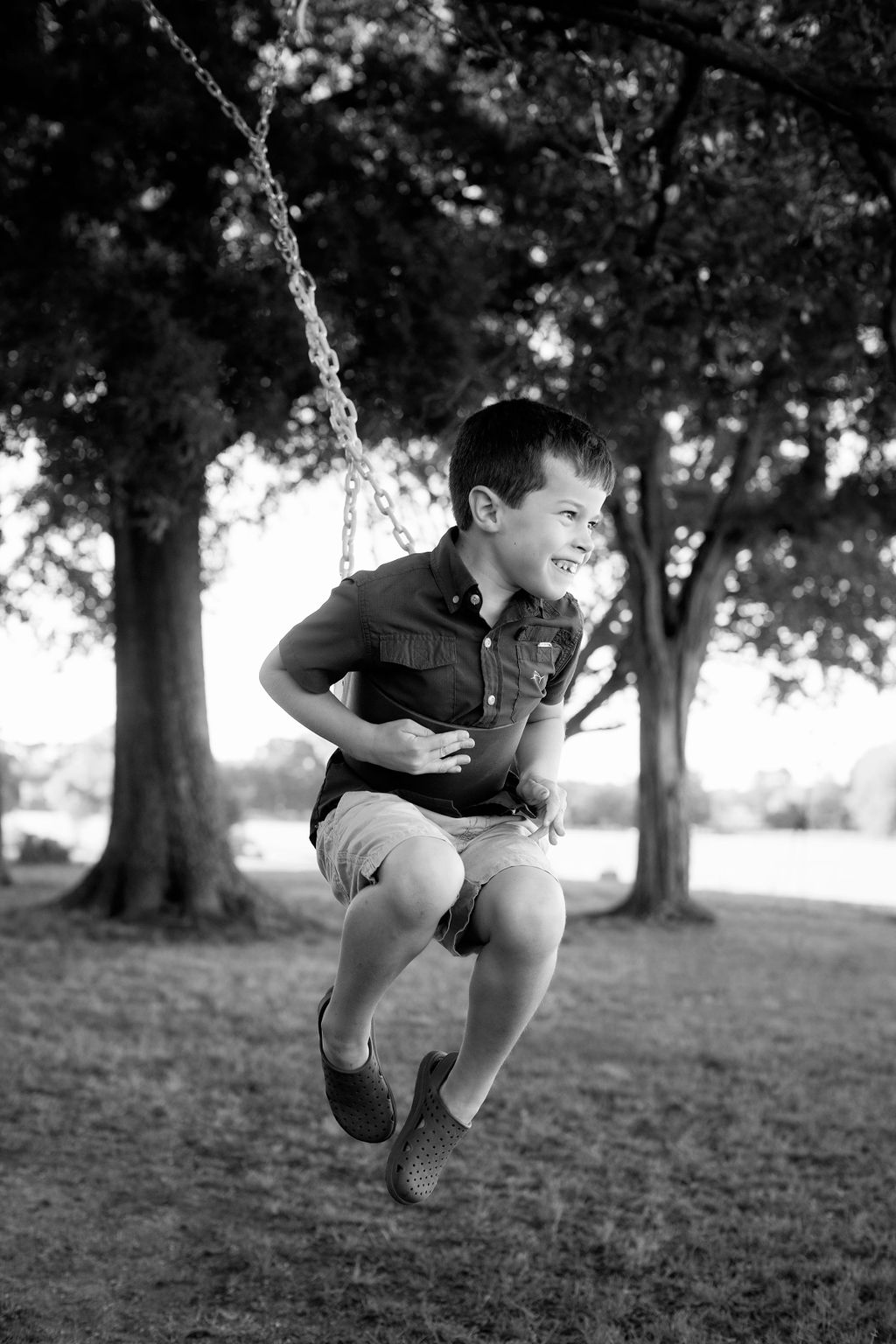 boy on swing smiling portrait