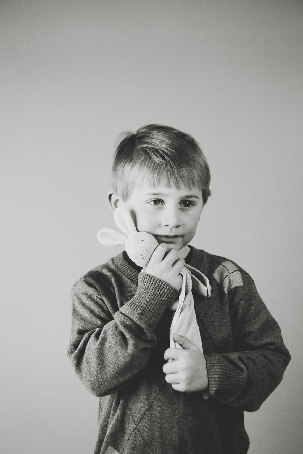 boy with stuffed animal black and white portrait