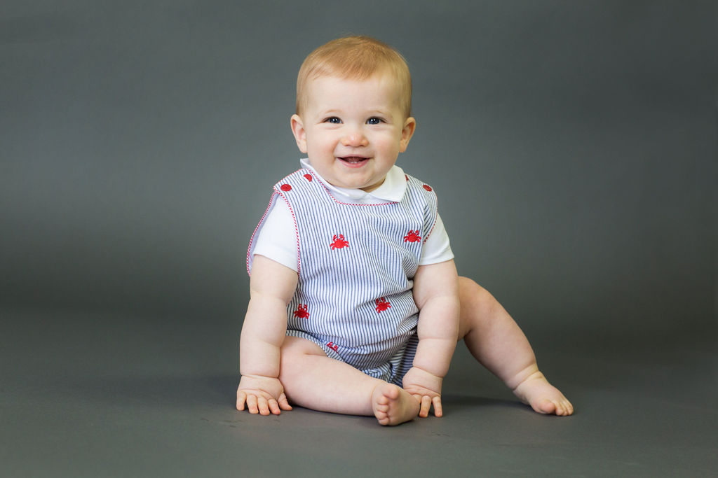 smiling baby in jumper studio portrait