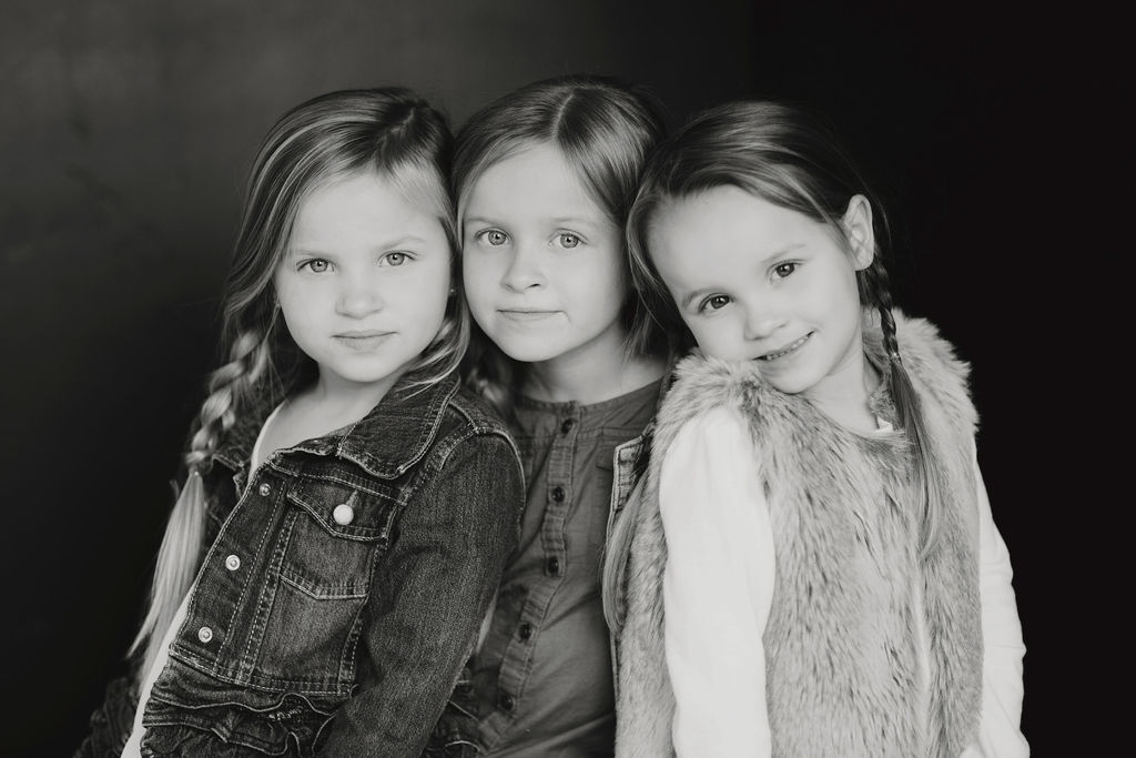 three sisters black and white studio portrait