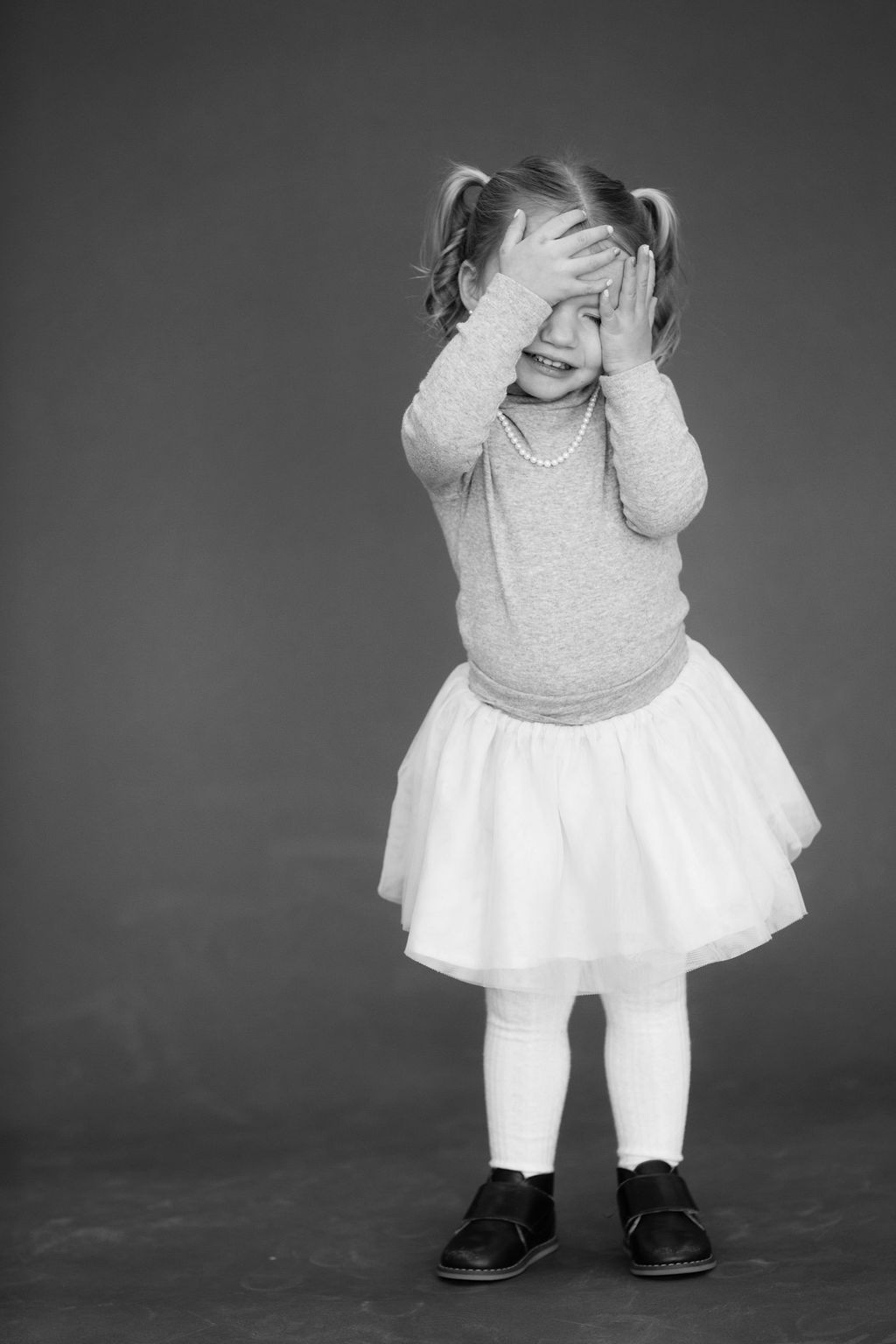 young girl covering eyes portrait