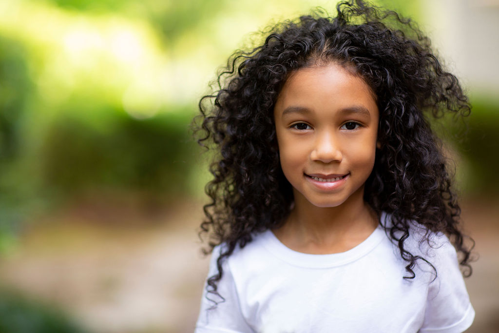 young girl curly long hair portrait